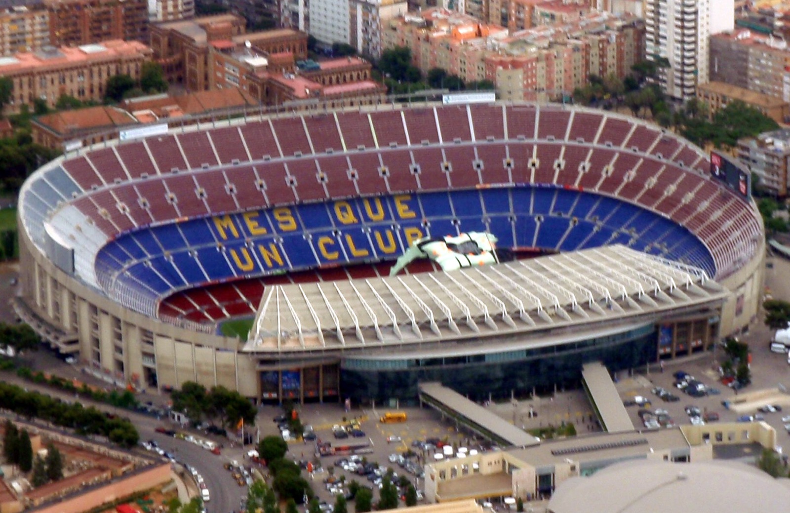 Aerial view of Camp Nou with "MÉS QUE UN CLUB" spelled out across the far stand